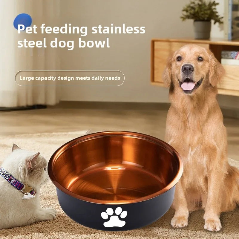 A dog and a cat sit beside a stainless steel dog bowl with a copper interior.