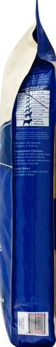 Side view of a blue pet food bag with ingredient list and nutritional information clearly displayed on the back.
