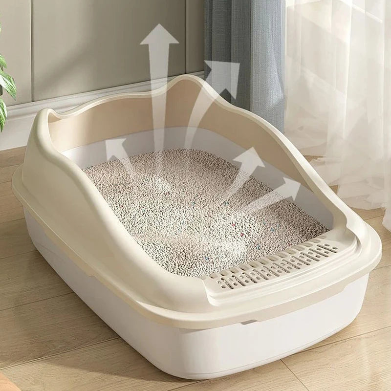 A clean litter box with white granules, featuring a raised design for easy access and airflow arrows indicating odor control.