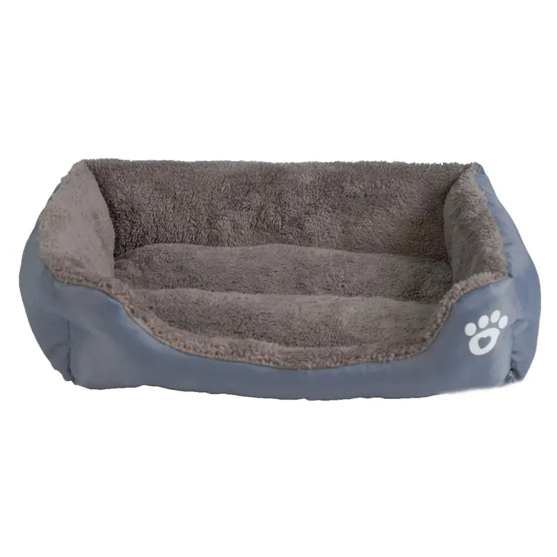 Cozy pet bed with soft gray fur interior and a smooth outer layer, featuring a white paw print logo on one side.