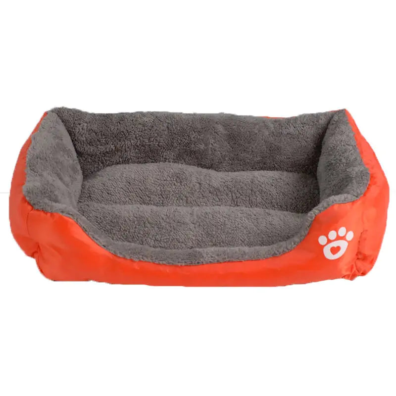 Cozy pet bed featuring a bright orange exterior and soft gray plush interior, designed for comfortable lounging.