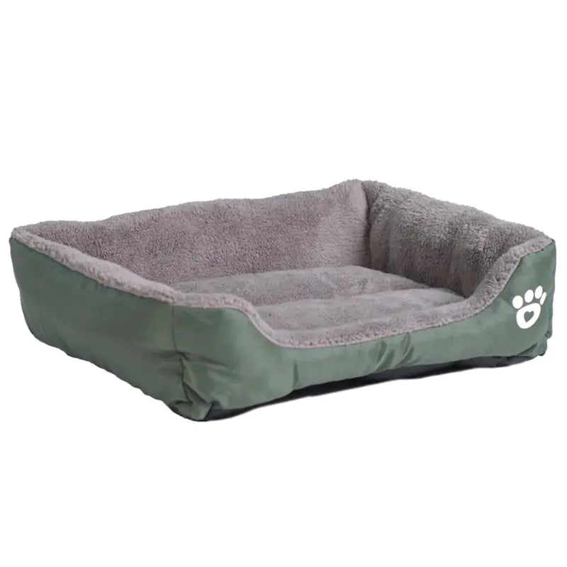 A cozy green pet bed with a plush gray interior and raised sides, featuring a white paw print design on one side.