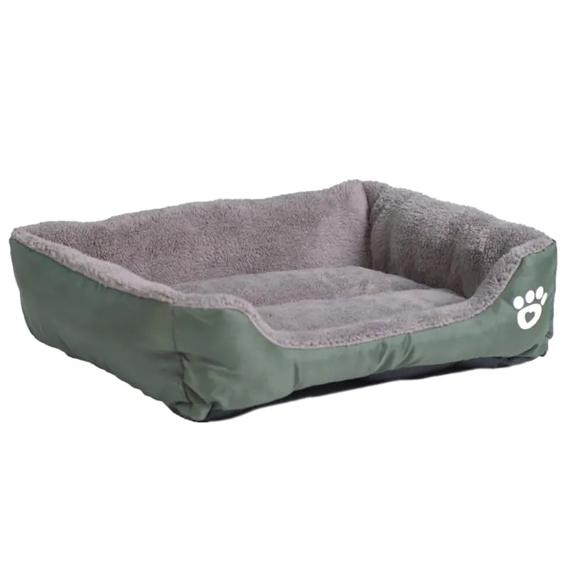 A cozy green pet bed with a plush gray interior and raised sides, featuring a white paw print design on one side.