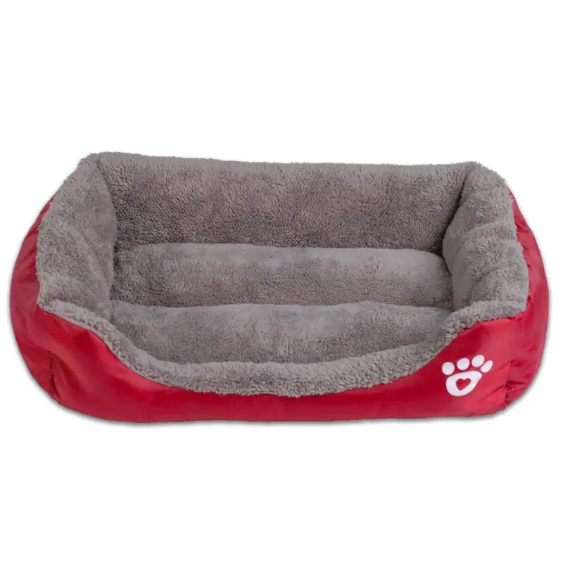 Cozy red pet bed with soft grey lining, featuring raised edges and a paw print design, perfect for pets to rest comfortably.