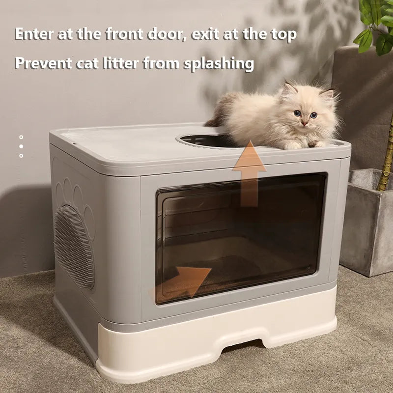 A fluffy cat lounges on top of a stylish litter box with a front entrance and top exit, designed to minimize litter spilling.