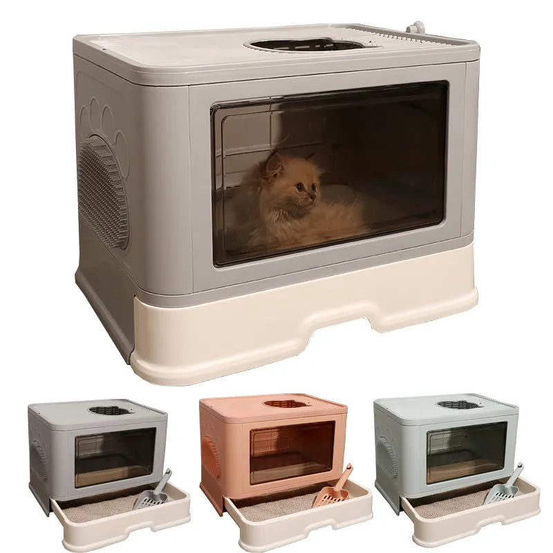 A modern cat litter box in gray, with a transparent front, surrounded by smaller boxes in pink and blue, equipped with a scooper.