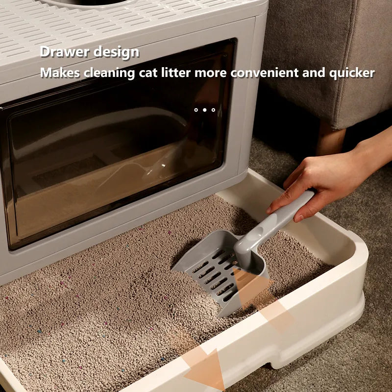 Hand using a scooper in a drawer-style cat litter box, highlighting its convenient design for quick and easy cleaning.