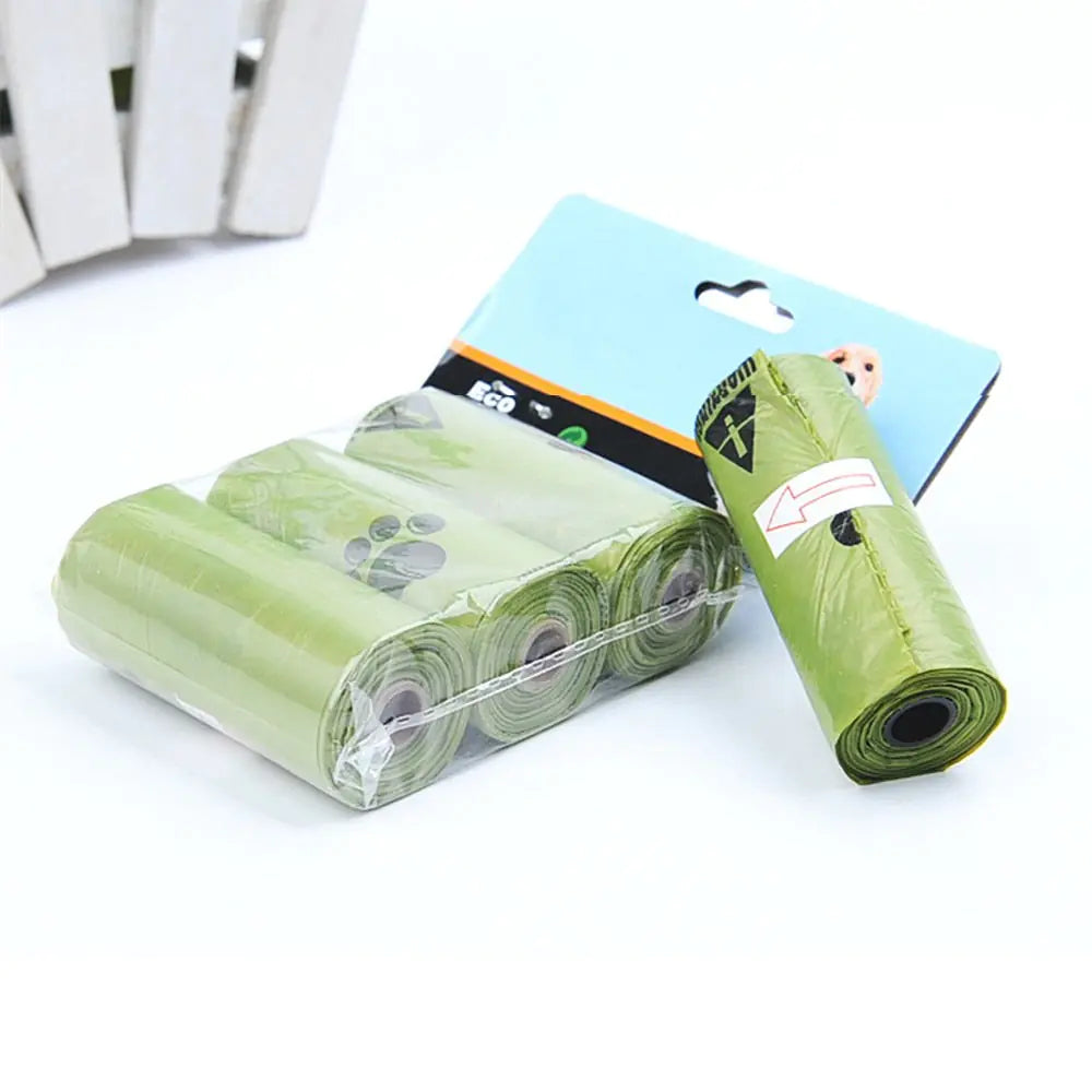 Green biodegradable dog waste bags in rolls, packaged with eco-friendly branding, ideal for pet owners.