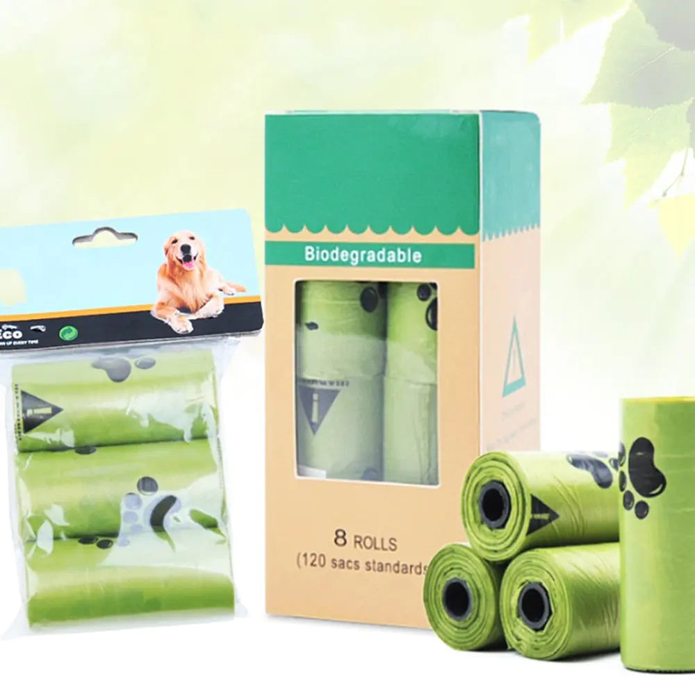 A package of biodegradable dog waste bags, featuring eight rolls with a playful paw print design and a hanging pouch of three rolls.