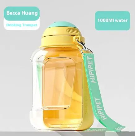 A clear water bottle with a yellow cap and mint green accents, labeled "Drinking Trumpet" and "1000MI water."