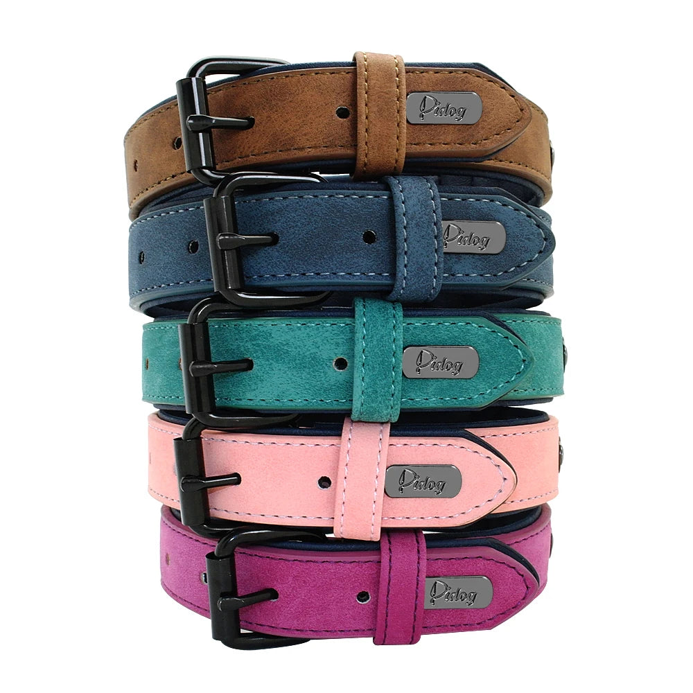 A stack of vibrant dog collars in brown, blue, teal, pink, and purple, featuring black buckles and metal tags .