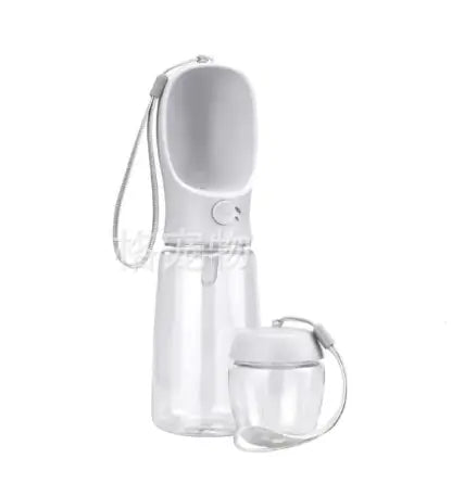 A sleek, transparent water bottle with a white cap and a detachable cup, featuring a wrist strap for portability.