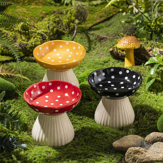 Set of three polka dot mushroom-shaped bowls on a grassy background