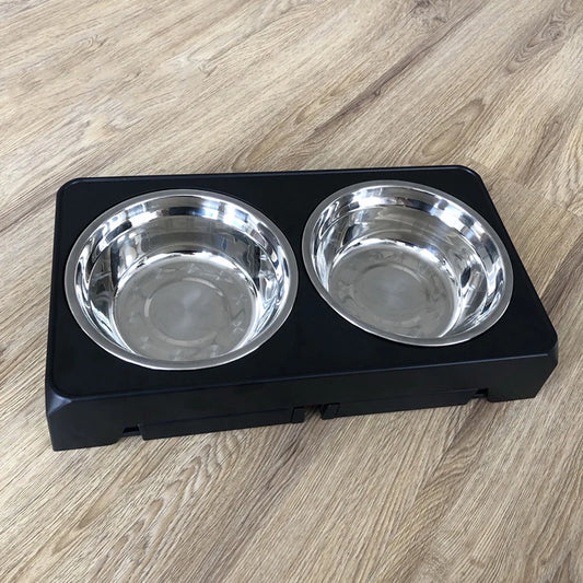 Two stainless steel pet food bowls set in a black plastic base.