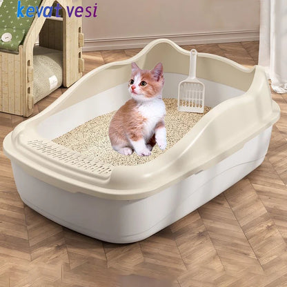 A cute orange and white kitten sits in a litter box with fine sand and a scoop, surrounded by a cozy home environment.