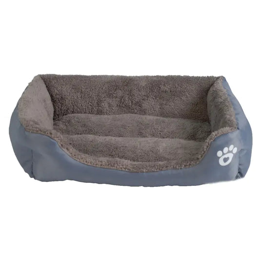 Cozy pet bed with soft gray fur interior and a smooth outer layer, featuring a white paw print logo on one side.