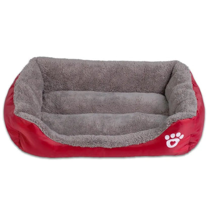 Cozy red pet bed with soft grey lining, featuring raised edges and a paw print design, perfect for pets to rest comfortably.