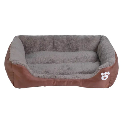 Cozy dog bed with a plush gray interior and brown exterior, featuring a white paw print emblem on the side.