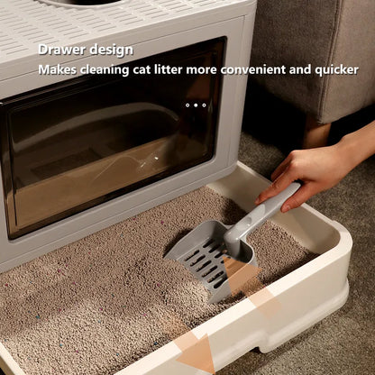 Hand using a scooper in a drawer-style cat litter box, highlighting its convenient design for quick and easy cleaning.