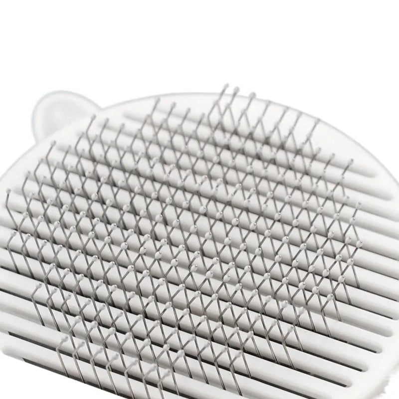 Close-up of a white grooming tool featuring closely spaced, fine metal bristles in a grid pattern, ideal for detangling hair.