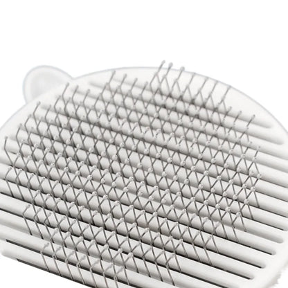Close-up of a white grooming tool featuring closely spaced, fine metal bristles in a grid pattern, ideal for detangling hair.