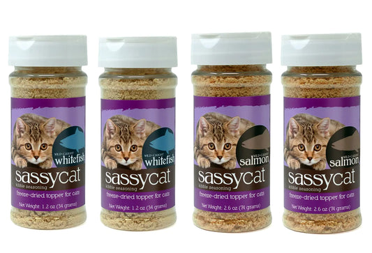 Four jars of Sassycat freeze-dried kibble seasoning for cats, featuring wild-caught whitefish and salmon flavors.