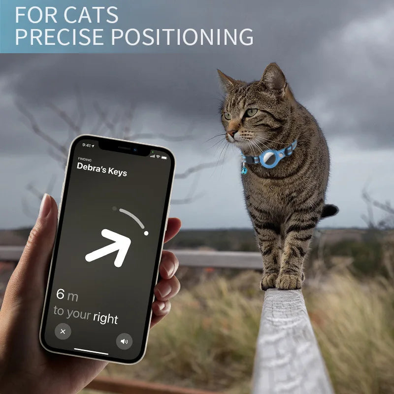 A hand holds a smartphone displaying a location tracker for finding a lost cat, with a tabby cat on a railing outdoors.