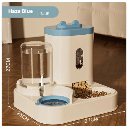 A blue automatic pet feeder with food chamber, measuring 27cm high and 27cm wide, set on a wooden floor. 