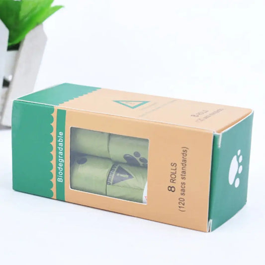 A box of biodegradable dog waste bags, containing 8 rolls (120 bags), displayed with a clear window and paw print design.