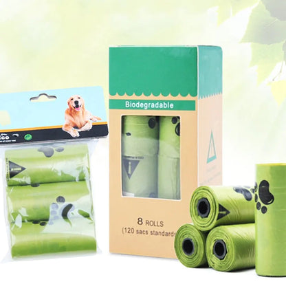 A package of biodegradable dog waste bags, featuring eight rolls with a playful paw print design and a hanging pouch of three rolls.