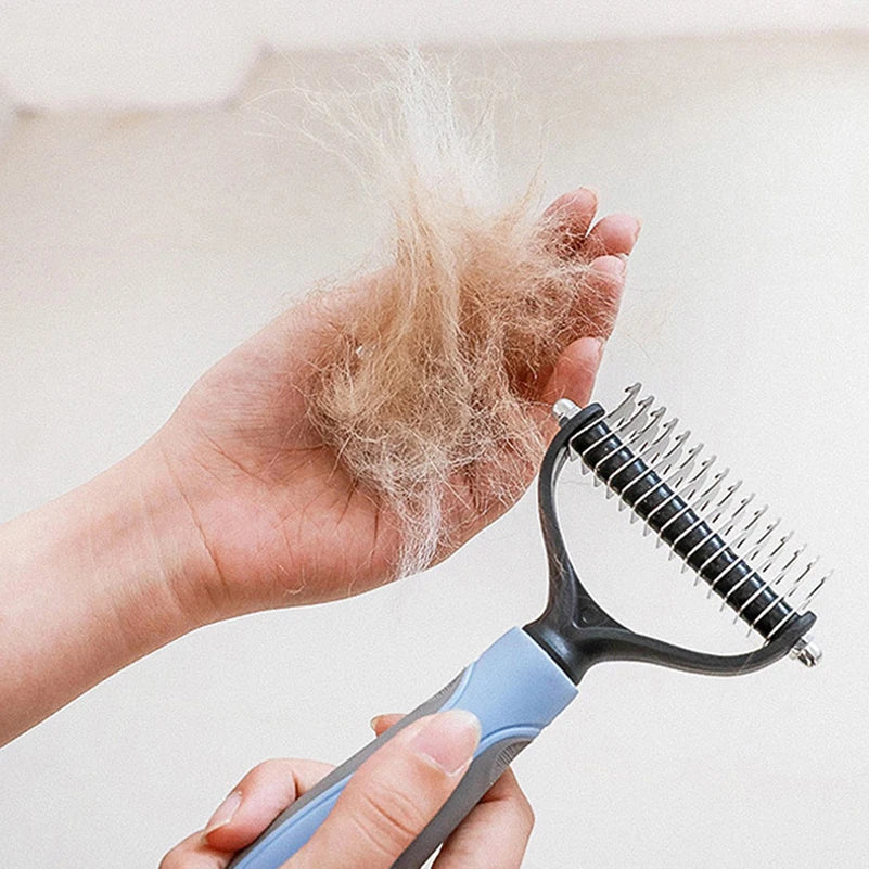 Hand holding pet hair with a grooming tool, showing fur removed during grooming.