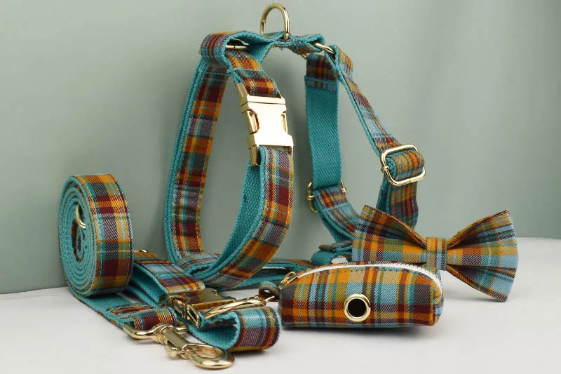 Dog harness, leash, and bow tie set with plaid pattern on a light gray background