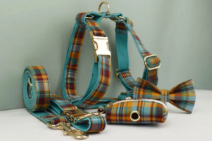 Dog harness, leash, and bow tie set with plaid pattern on a light gray background