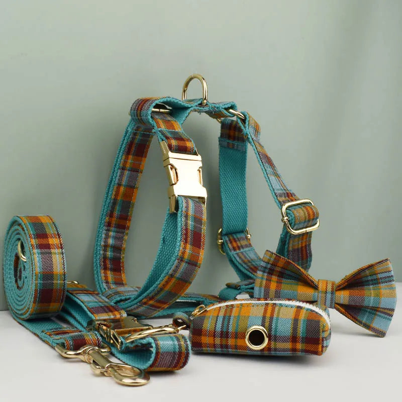 Plaid dog harness, leash, and bow tie set on a light gray background