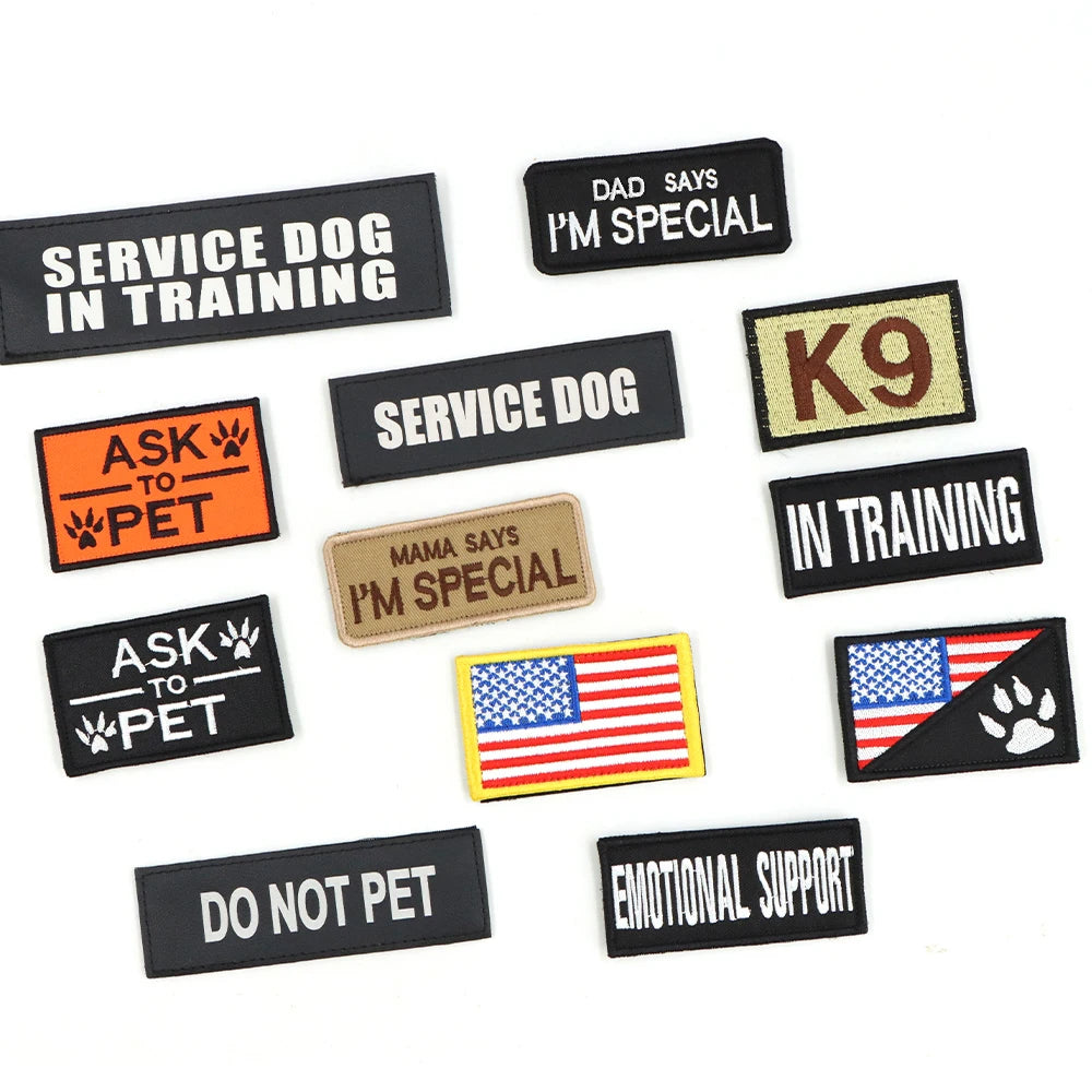 Collection of various dog patches with different messages on a white background