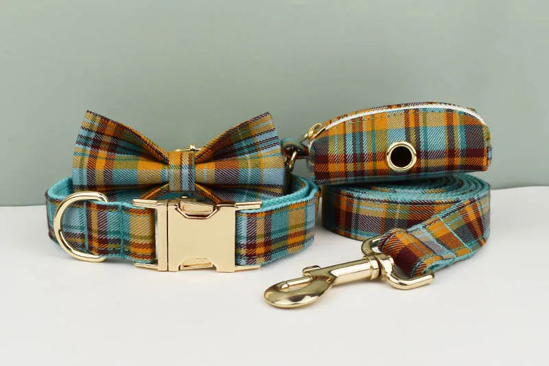 Plaid dog collar, bow tie, and leash set on a light gray background