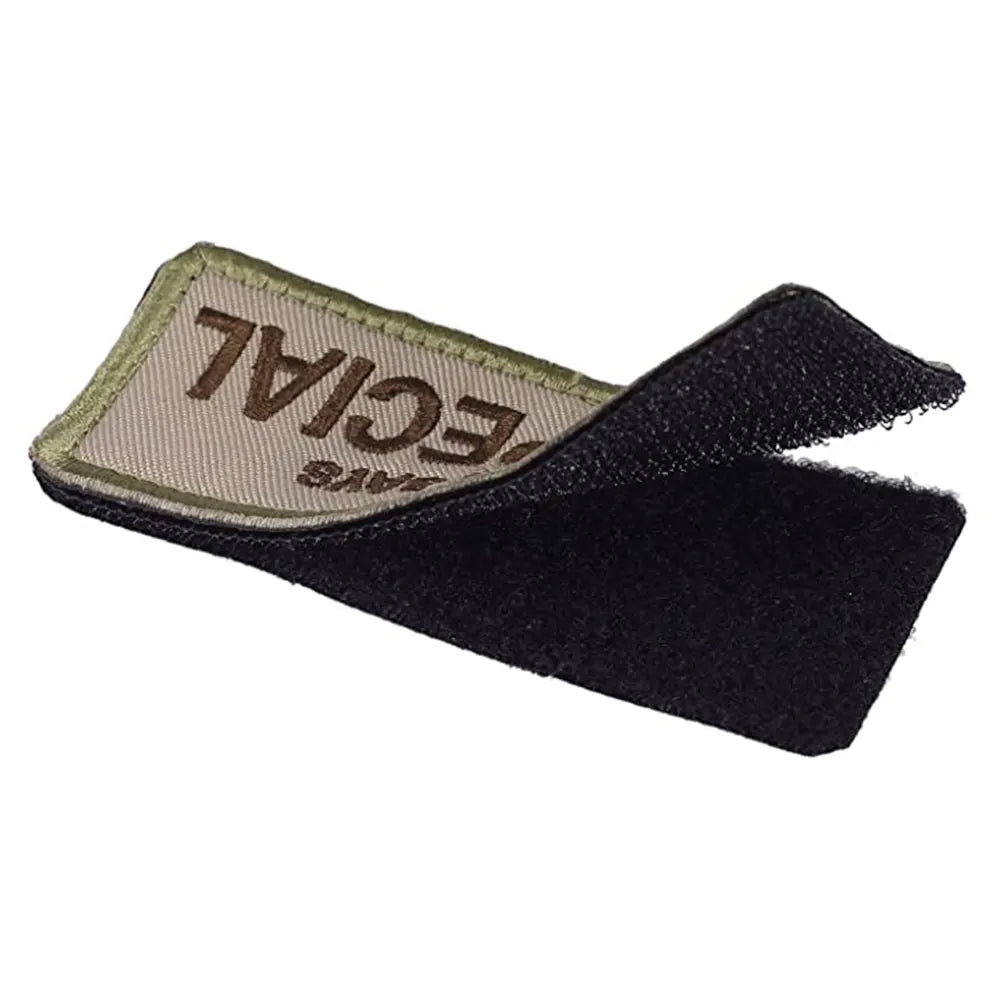 Black velcro strap with a beige label on a white background