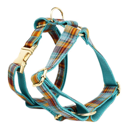 Plaid dog harness with gold hardware on a white background