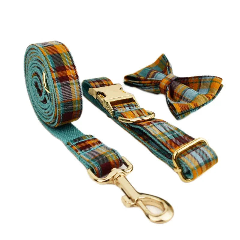 Plaid dog leash and bow tie set with gold hardware on a white background