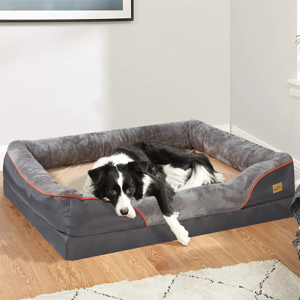 Dog lying on a gray pet bed with orange accents in a room.