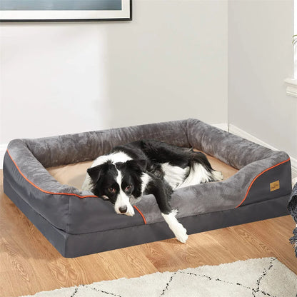 Dog lying on a gray pet bed with orange accents in a room.