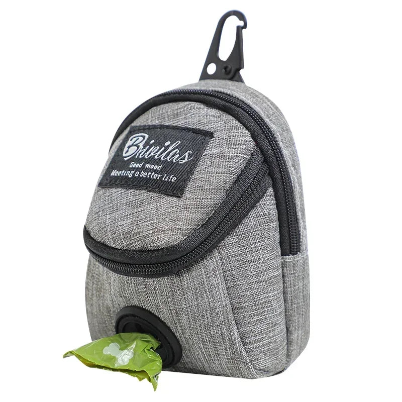 Gray pet waste bag dispenser with a green bag attached on a white background