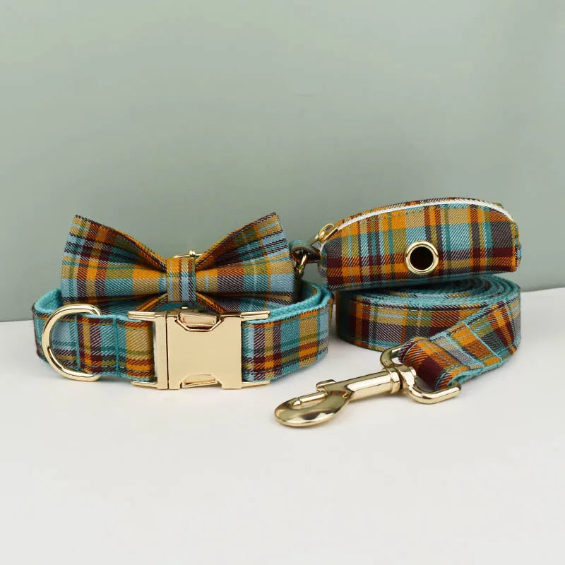 Plaid dog collar, bow tie, and leash set on a light gray background