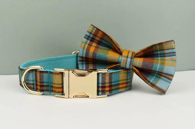 Plaid dog collar with a bow tie on a light gray background